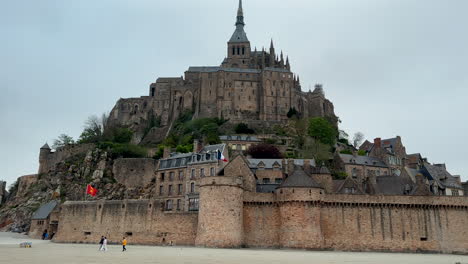 panoramic shot of beautiful historic le mont-saint-michel cathedral on mountain during ebb tide in france