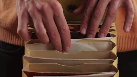 man hands browsing vintage vinyl records in special bag close-up. searching music. musical shopping. retro vinyl record player. high quality 4k footage