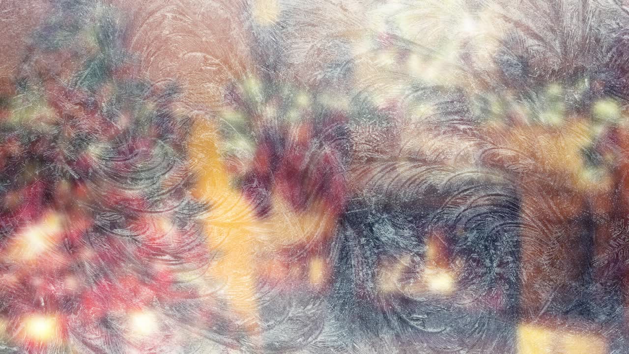 Swirling frost patterns on glass with blurred fireplace in background. Artistic winter overlay. Seamless loop