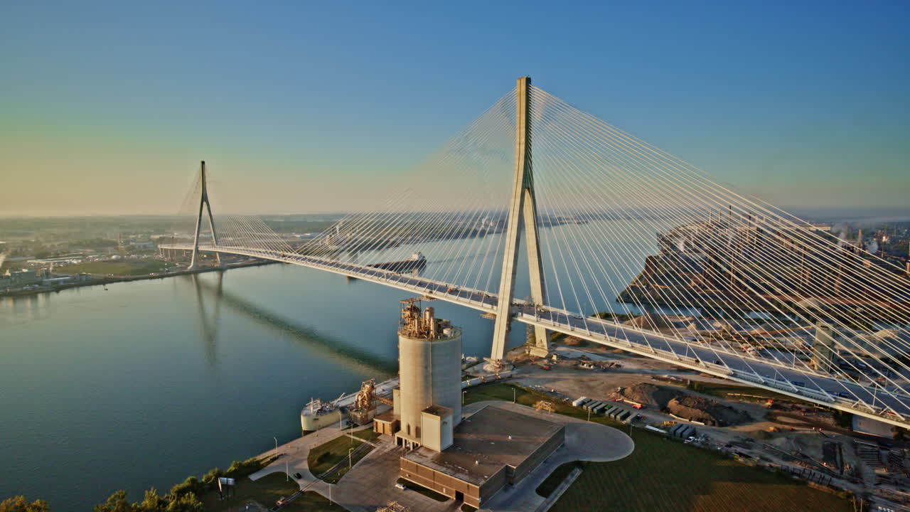 Aerial footage of a freighter navigating the waters under the Gordie Howe Bridge