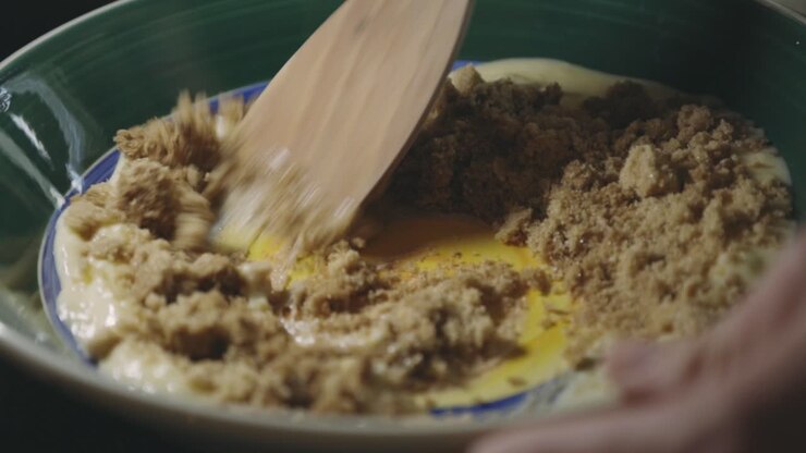 Adding A Cup Of Brown Sugar To Cookie Batter - close up