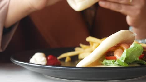 woman eating a burger in a restaurant