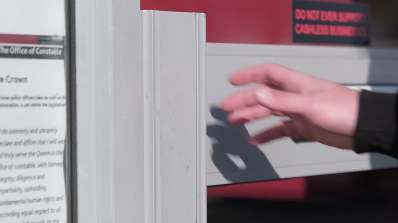 Close up of male hand opening door into shop as he is walking in slow motion.