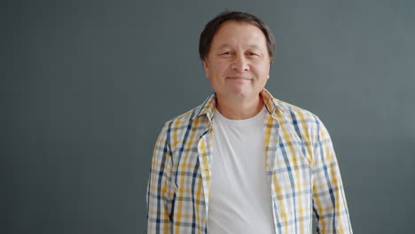 smiling asian man greeting