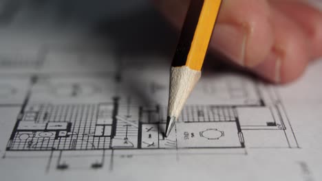 professional architect draws over blueprint, creative designer reviews drawings