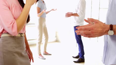 Young-coworkers-shaking-hands-