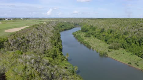 Majestic-flight-over-the-Chavon-River,-Casa-de-Campo