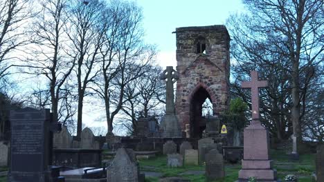 Medieval-Windleshaw-Chantry-stonework-tower-graveyard-slow-motion-around-ruins-against-blue-sky