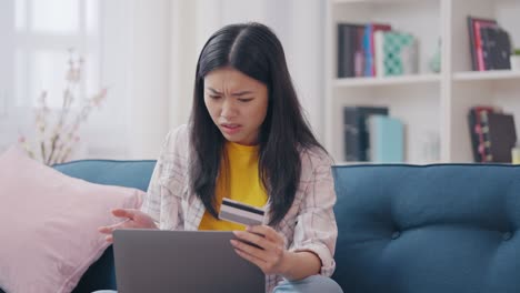 asian female falling victim to online scam, credit card phishing, identity theft