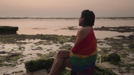 lgbtq+ woman at sunset beach