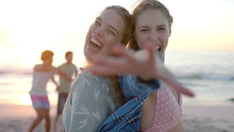 two young caucasian women enjoy a playful moment on the beach at a party