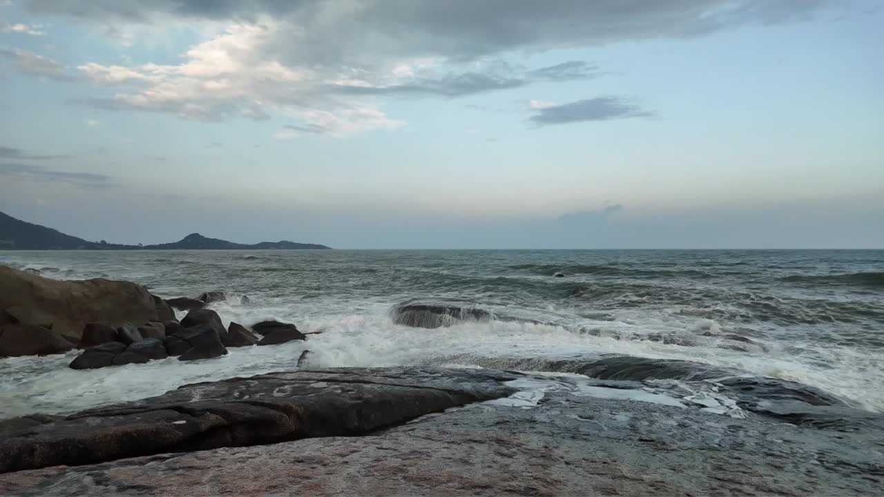 Slow Motion of Small Waves Crashing onto Large Rocks
