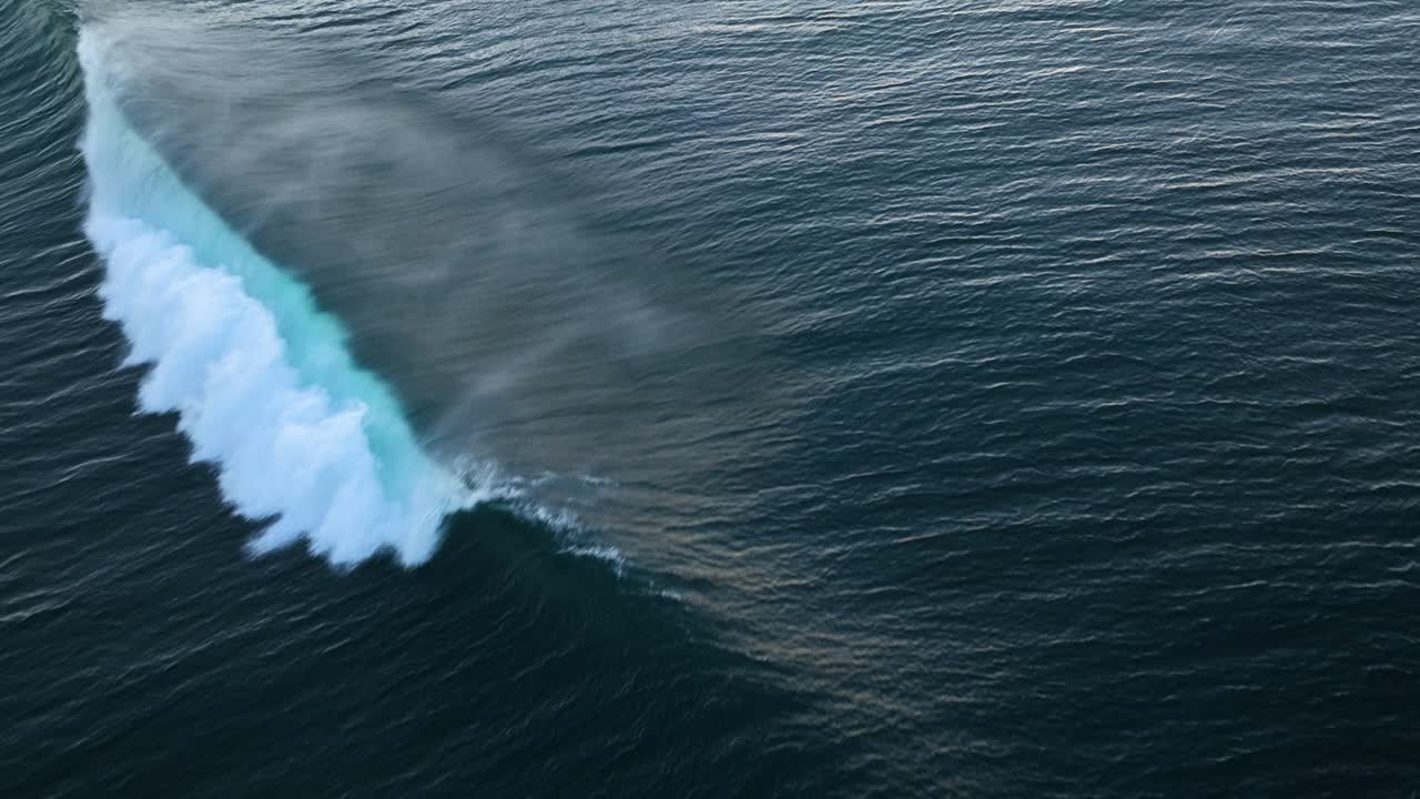 Drone view of perfect ocean wave breaking diagonally across frame, Azores