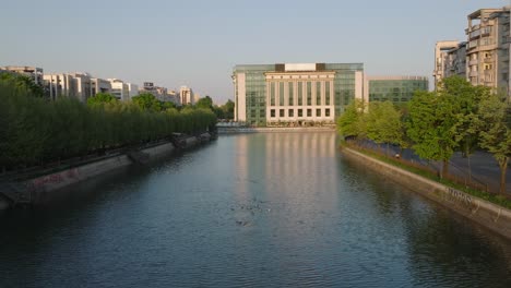 aerial forward flight over river towards palace of parliament in bucharest