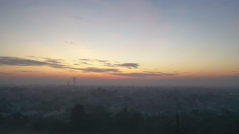 sunrise over a city with fog