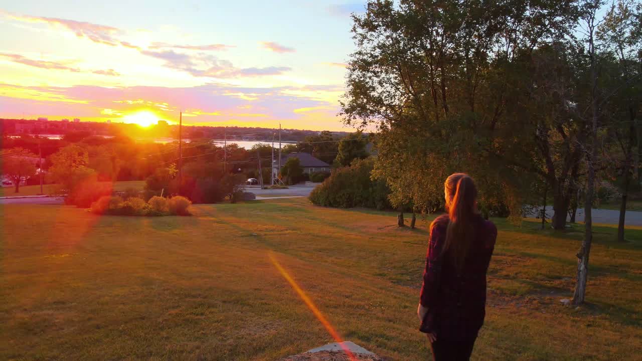 women over looking a city during fall Sunset