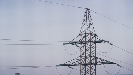 high voltage power pylon at clear sky drone shot. parts of electrical equipment.