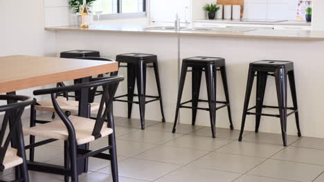 stone bench top kitchen with bar stools with adjacent dinging table