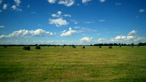 bales of hay on the field with beauty cloud sky