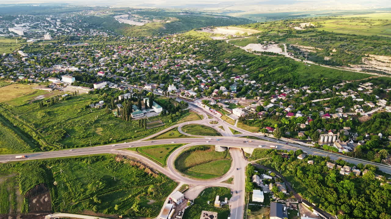 Aerial drone view of a village and road with cars, greenery, Moldova