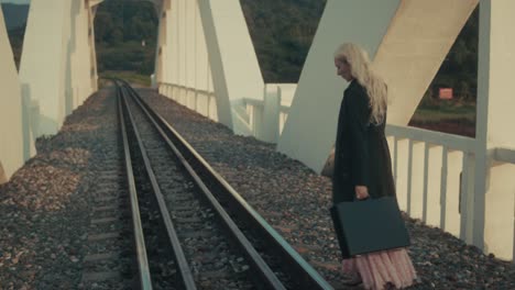 woman on a bridge with a briefcase