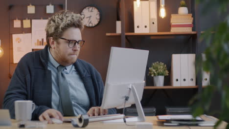 man working at a computer in an office