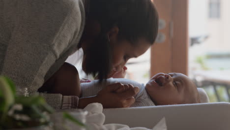 young mother kissing happy baby laughing enjoying loving mom nurturing toddler at home