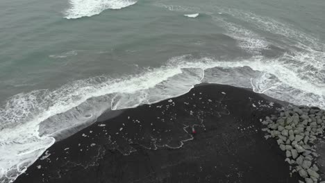 aerial of diamond beach in iceland, with black sand and ice blocks