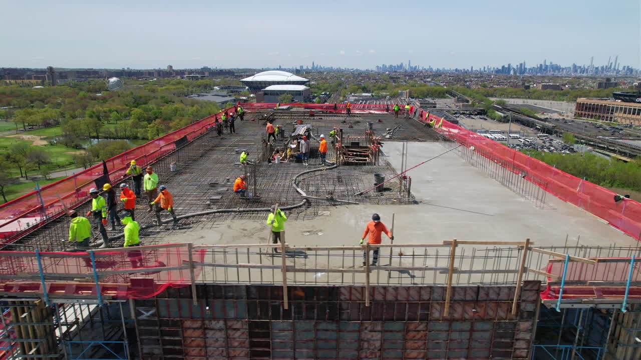 Drone pan view of Construction workers with Highrise