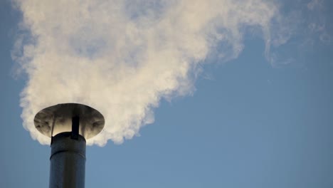 smoke from a wood burning stove coming out of the chimney