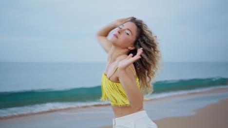 choreographer performing dance beach moving flexible body. curly dancer woman