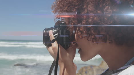 spot of light against african american female photographer clicking pictures with digital camera