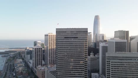 aerial view of a modern city skyline at dusk with skyscrapers and a waterfront