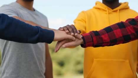 diverse hands stacked together symbolizing teamwork and unity