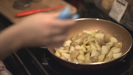 putting flavors on the potatoes in the frying pan