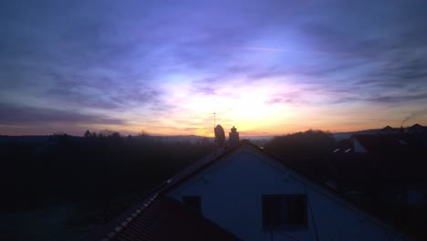 purple and blue early morning dramatic sunrise across silhouette tree line in germany in 4k