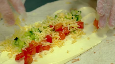 CU-Slow-motion-Cook-prepares-wok-sprinkles-fresh-vegetables-with-cheese