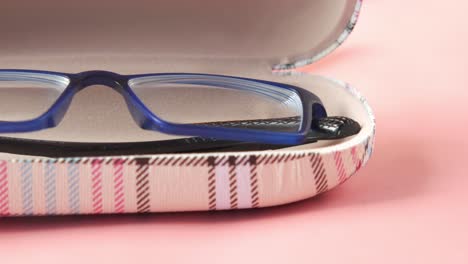 blue eyeglasses in a patterned case