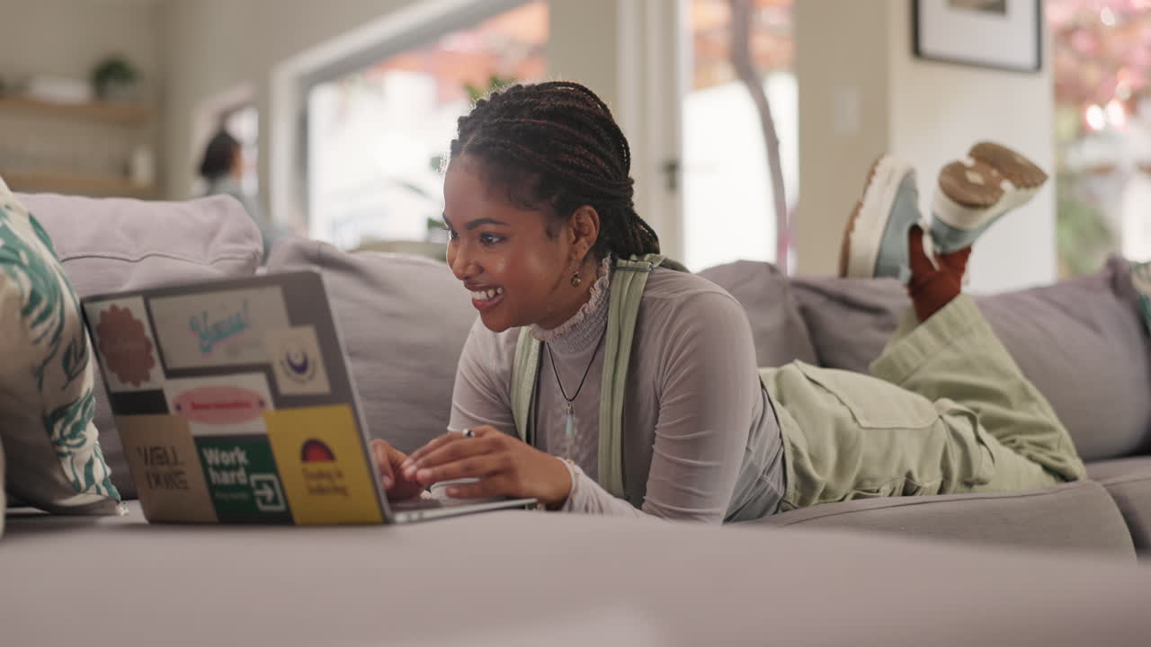 Woman using laptop on couch at home