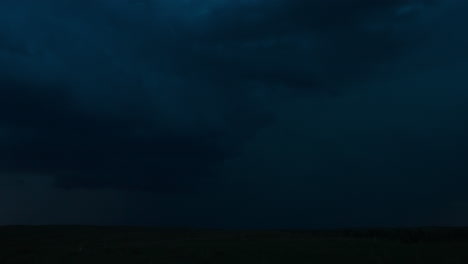 dark storm clouds with lightning over a horizon