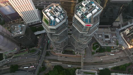 drone lifting tilt shot of the high lippo towers and busy highways in hong kong