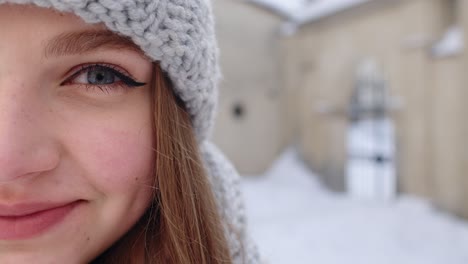 Portrait-of-Caucasian-pretty-happy-girl-with-smile-on-face-posing-on-winter-citystreet-background