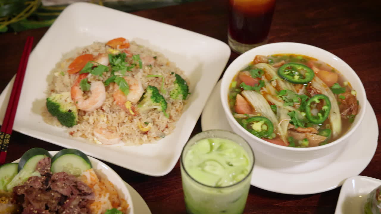 Assortment of vibrant Vietnamese restaurant dishes, overhead slider 4K
