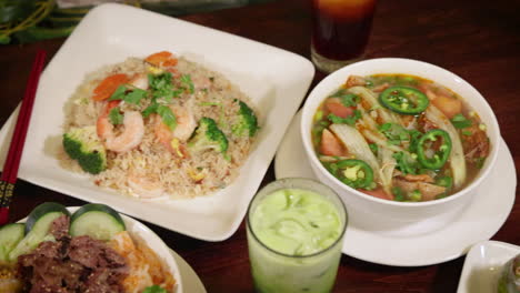 assortment of vibrant vietnamese restaurant dishes, overhead slider 4k