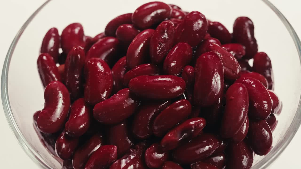 Canned red bans preserved beans rotating background close up side view. Organic steamed beans. Pickled bean for a Mexican dish