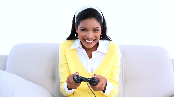 Woman playing video games on sofa