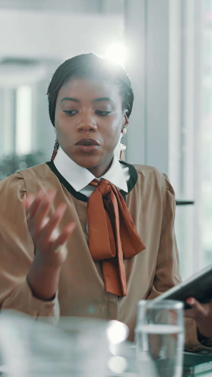 Professional African American Woman Talking and Gesturing in an Office Meeting
