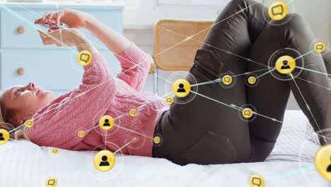 Animation-of-profile-icons-connecting-with-lines-over-caucasian-woman-using-phone-and-lying-on-bed