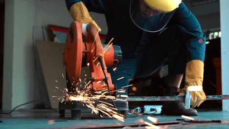 professional mechanic is cutting steel metal.