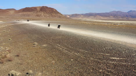 group of motorcyclists escaping and going into exile in the desert, trona pinnacle desert